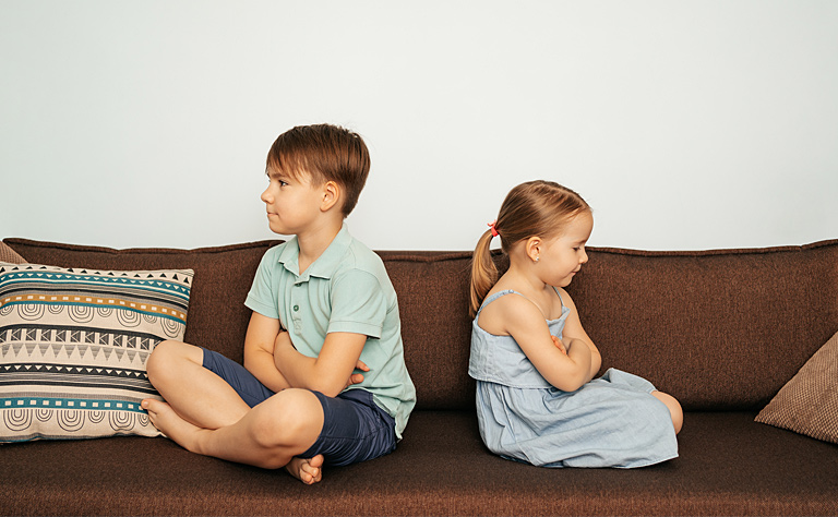 two children facing away from each other